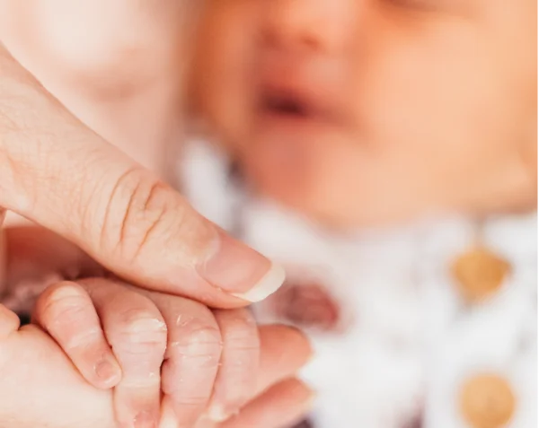 Alexis and her newborn baby holding hands Alexis and her newborn baby holding hands